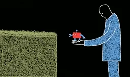 a man offering a small robot to a hedge