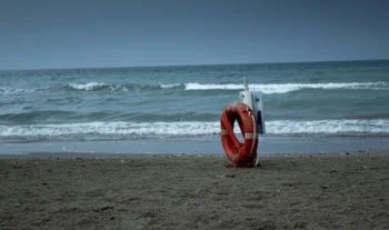 A lifebuoy on the beach.