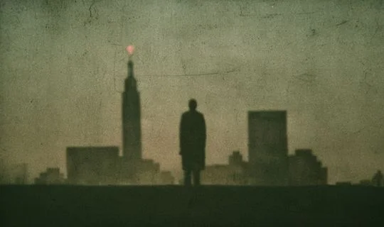 silhouette of a man looking at Manhattan 