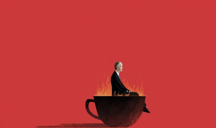a man sitting in a flaming cup 