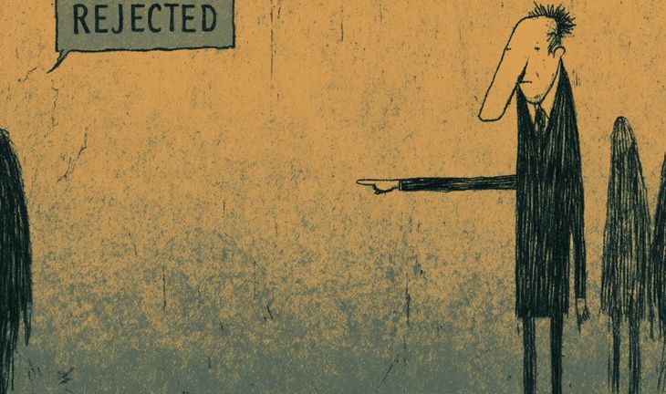 A man pointing and a sign that says rejected