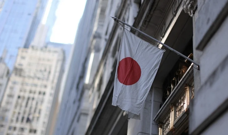 a Japanese flag on a building in a city