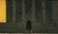A man in a long coat standing outside a court room 