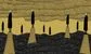 some people standing on gold pillars in a black sea 